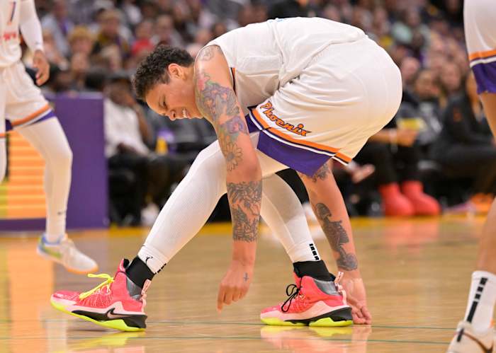 Phoenix Mercury center Brittney Griner falls down on the court.